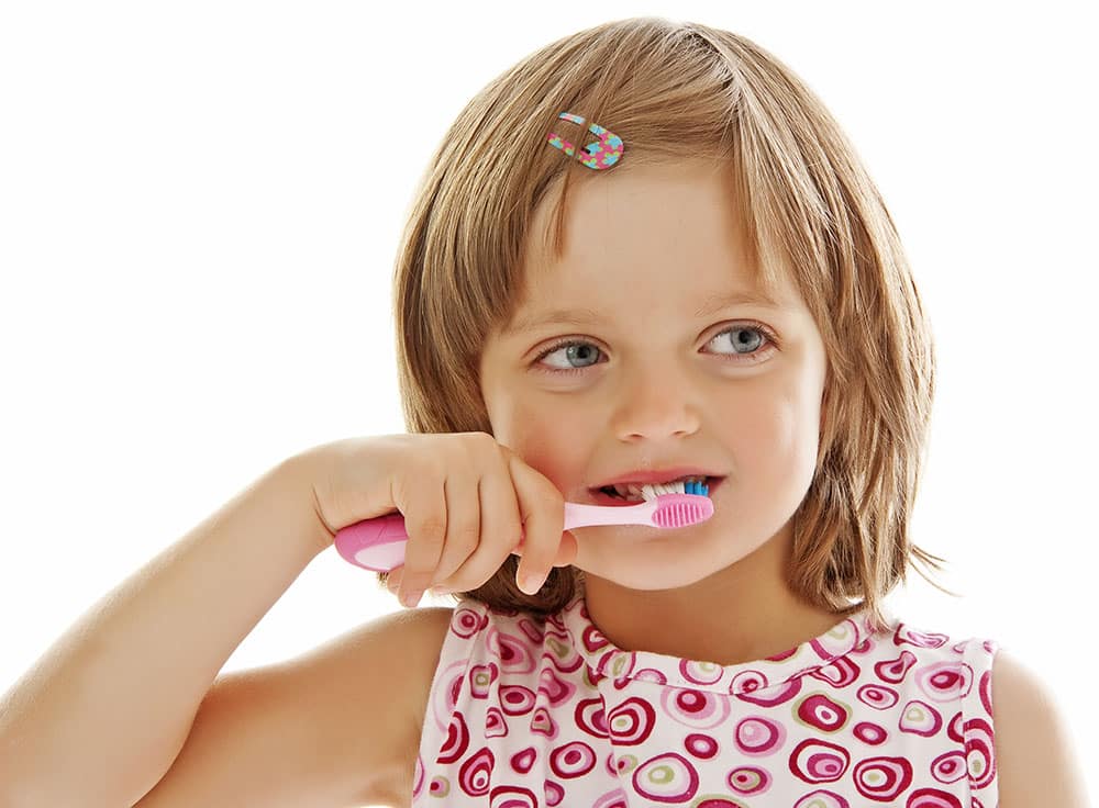 cute girl brushing her teeth