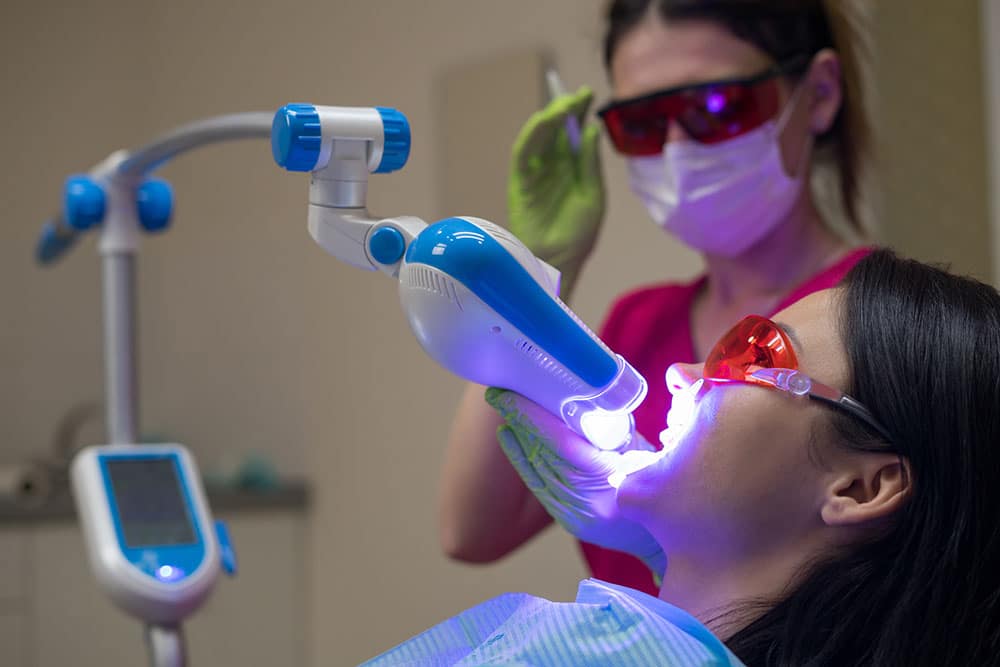 dentist performing oral cancer screening