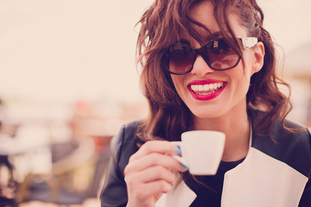 girl taking a cup of tea after getting veneer