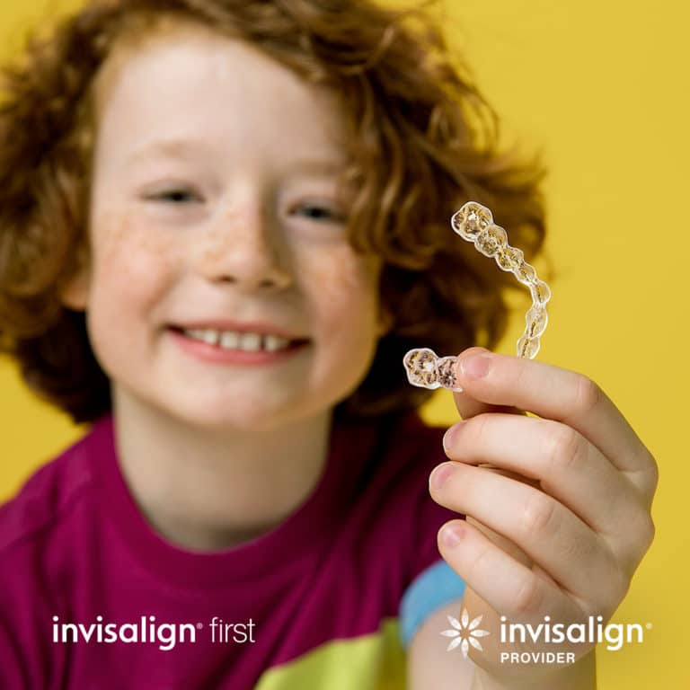 kid holding invisalign first