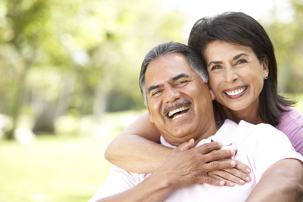 middle aged couple smiling with denture